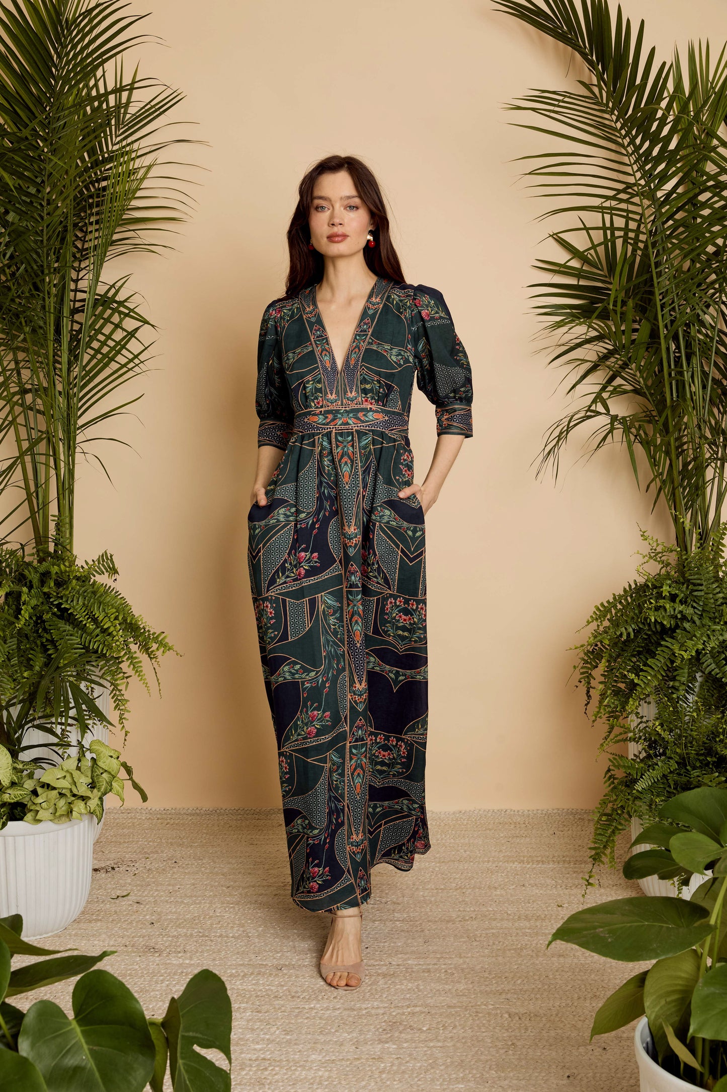 Full-length view of model wearing the Aneta Dress in Patchwork Flower with hands in pockets, highlighting the relaxed drape and maxi length