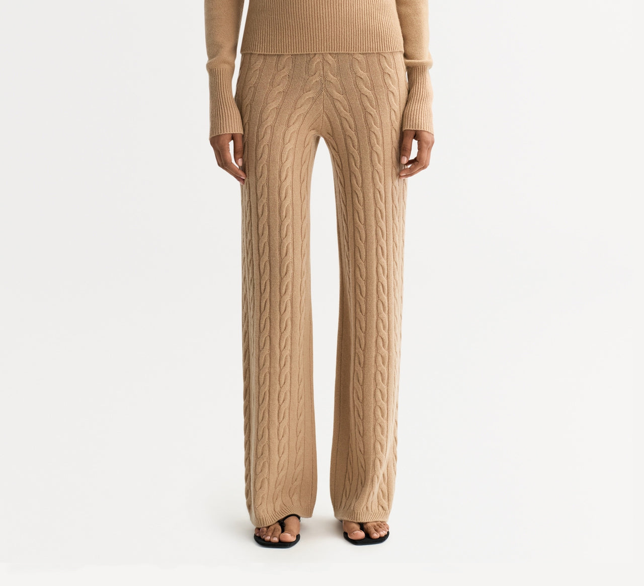 Model wearing camel cable knit wide-leg pants with a soft textured knit design and relaxed fit.