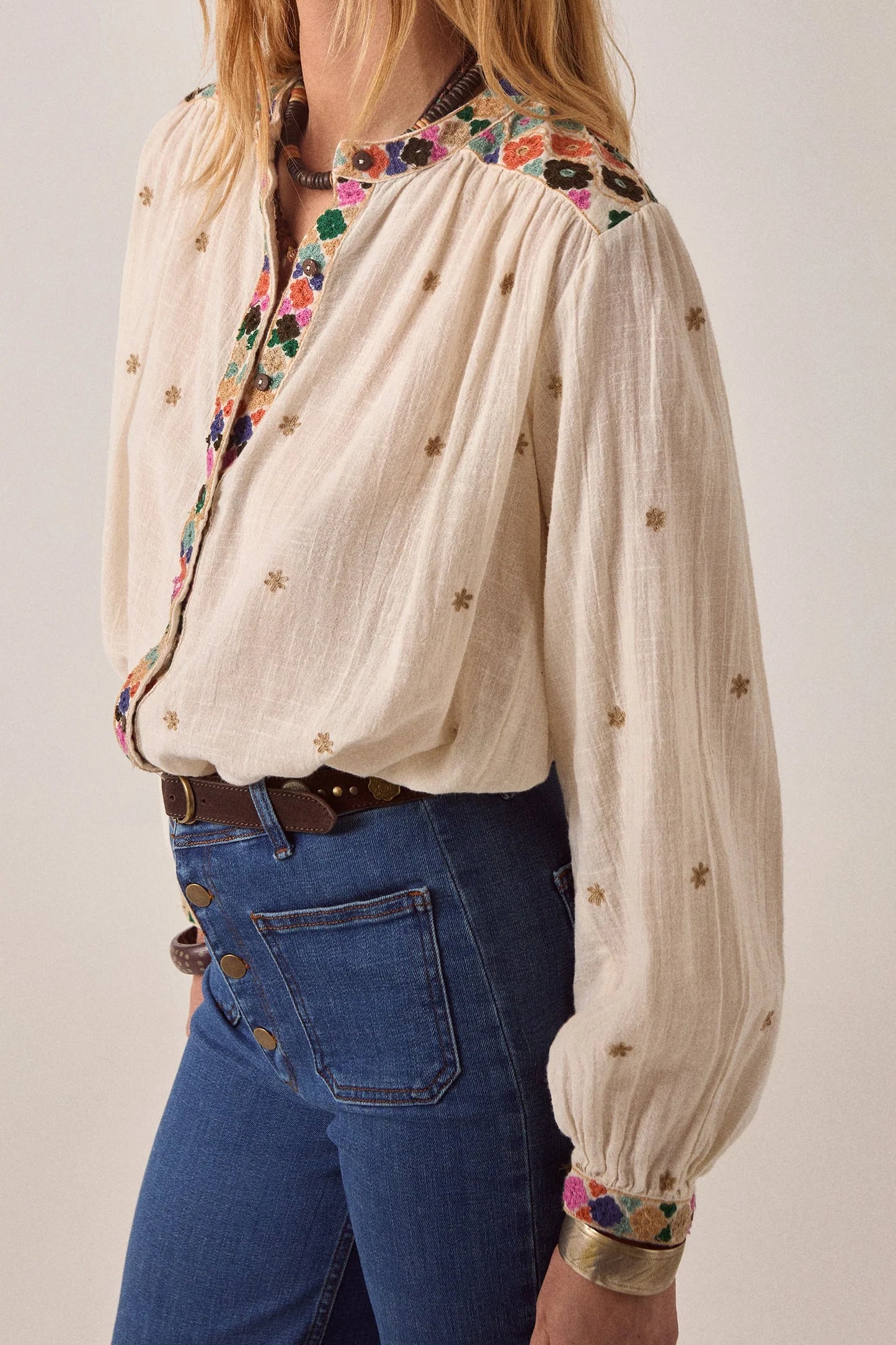 Detailed front view of the Cleo blouse featuring multicolor floral embroidery on the yoke and placket with lightweight gathered fabric.