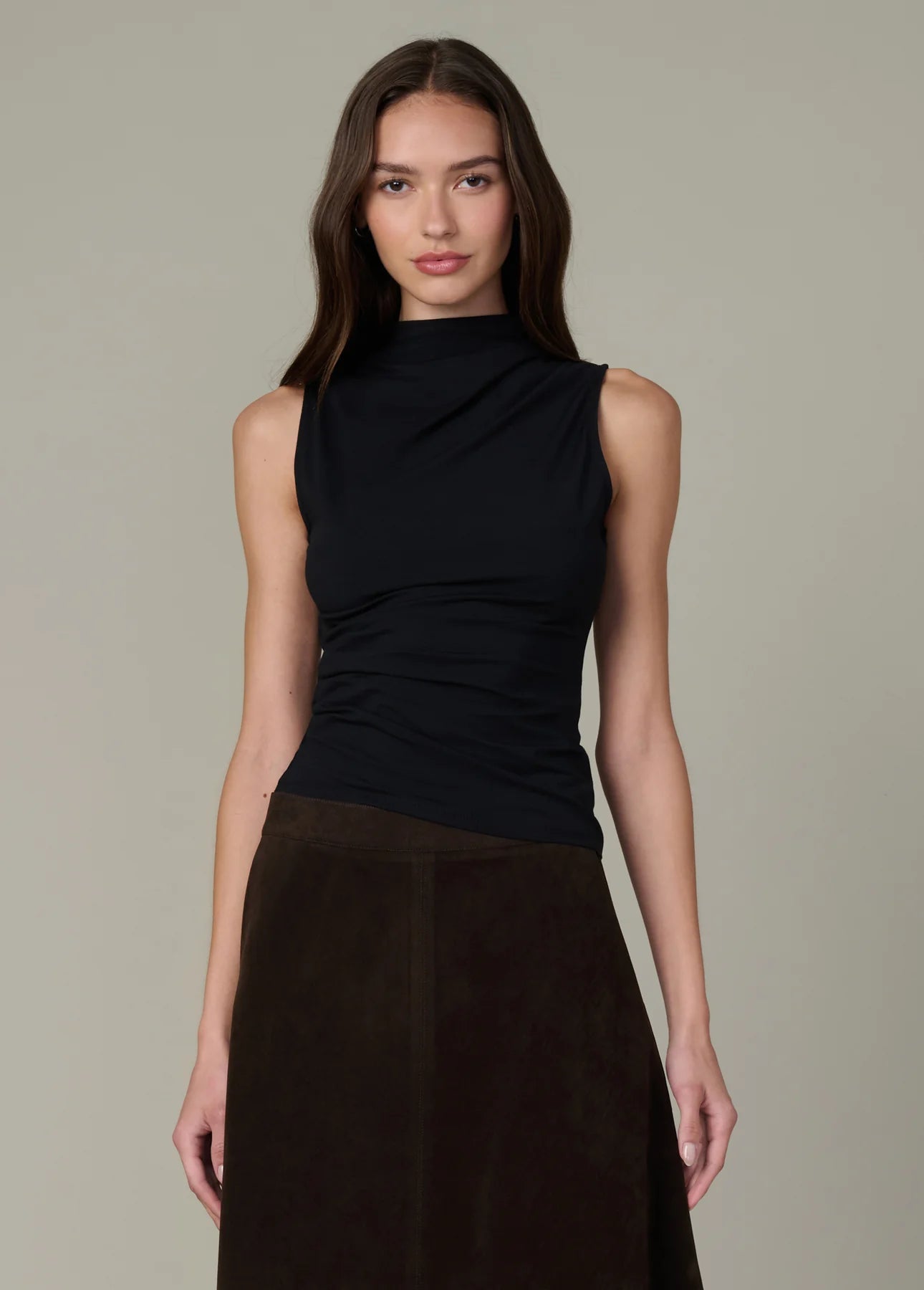 Front view of the black Dove Top featuring a sculpted fit, asymmetric draping, and standing collar.