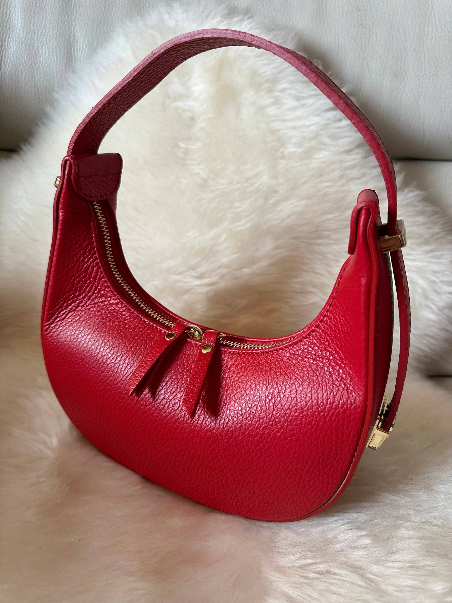 Elly mini hobo bag in red genuine dollarino leather with an adjustable shoulder strap, dual zip closure, and light gold-tone hardware, handcrafted in Italy.