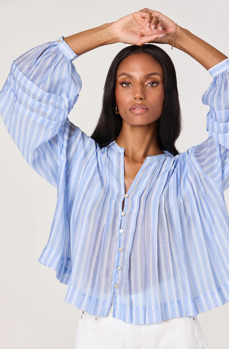 Close-up of the Ericka Top featuring soft blue and white stripes, partial button placket, and voluminous sleeves