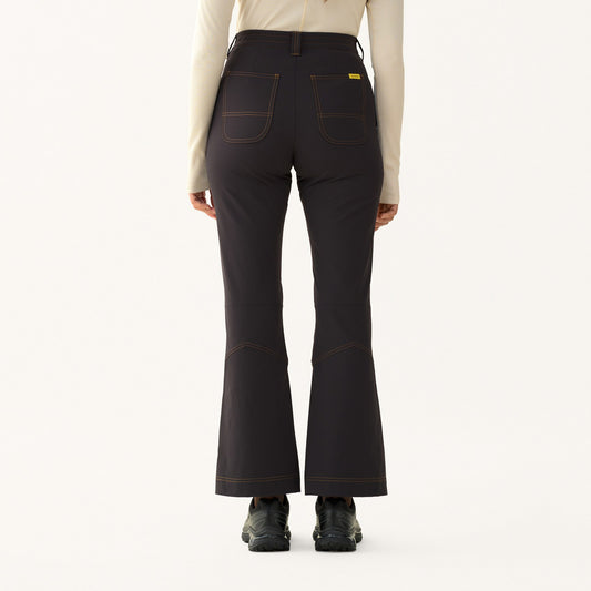 Back view of model wearing Hikerkind Kick Flare Trousers featuring a high-rise fit and flared legs.