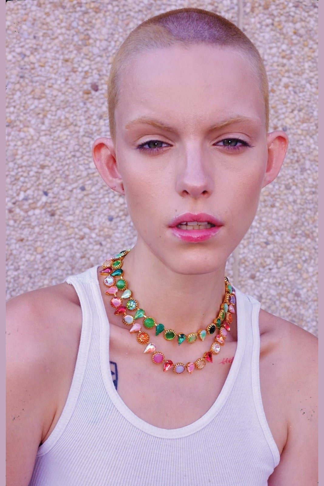 Model wearing the Layering Choker in Salad Gold with layered green vintage glass stones and gold plate settings.