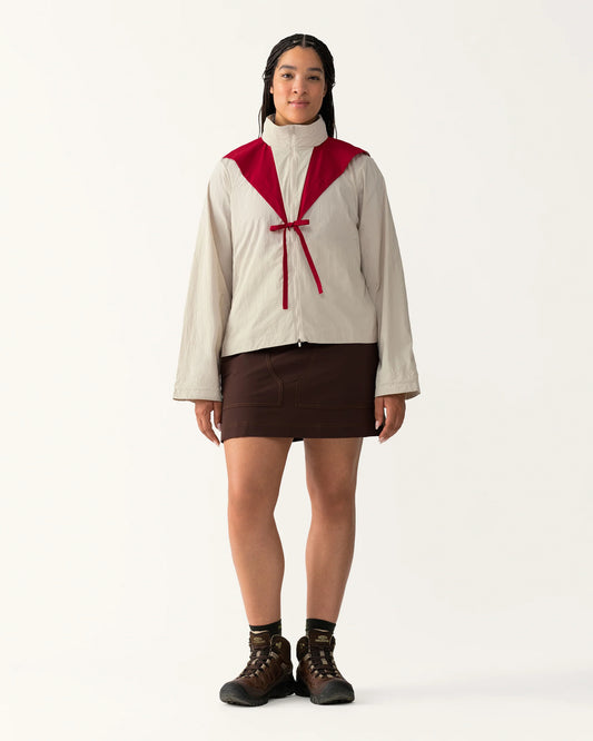 Full body view of Packable Windbreaker in Dolomite/Rowan styled with a skirt and boots