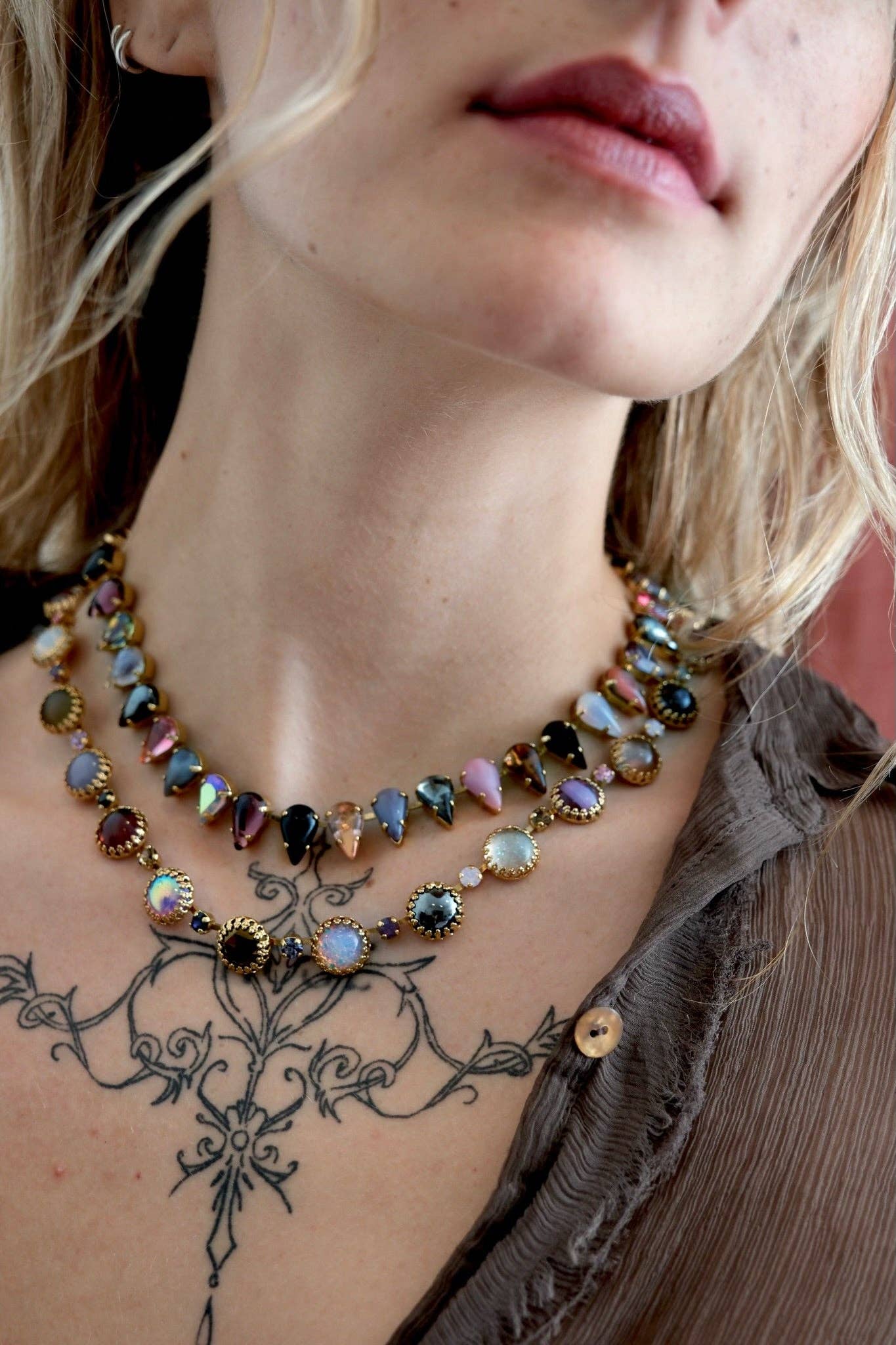 Close-up of the Paint Pot Layering Choker in Punk Rocks Gold styled with layered necklaces, featuring multicolor vintage glass stones and crystal accents.