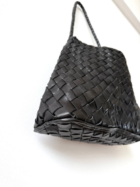 Angled view of the Palar Black Bag showing its handwoven leather texture