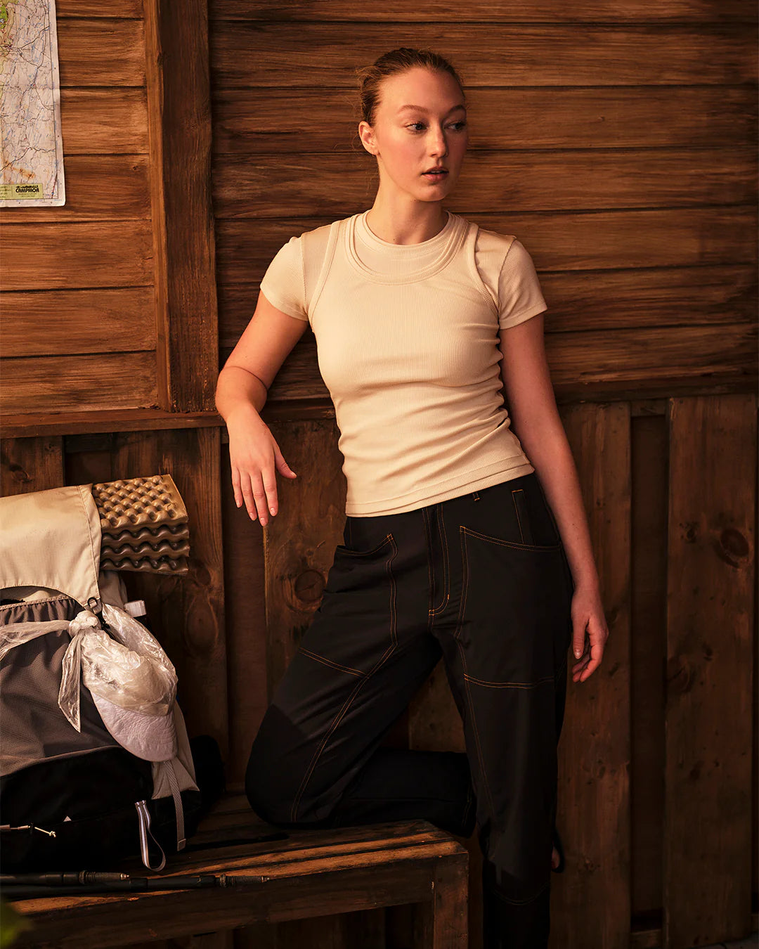 Model leaning while wearing Ribbed Merino T-Shirt showing flexibility and everyday wear styling