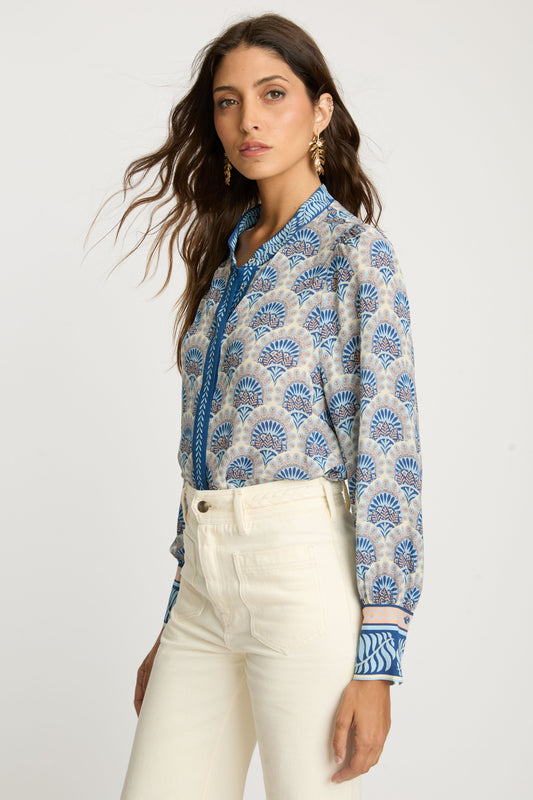 Side profile of the Riley Top in Boho Deco highlighting the fluid viscose drape, relaxed fit, gathered sleeves, and contrasting blue patterned cuffs.