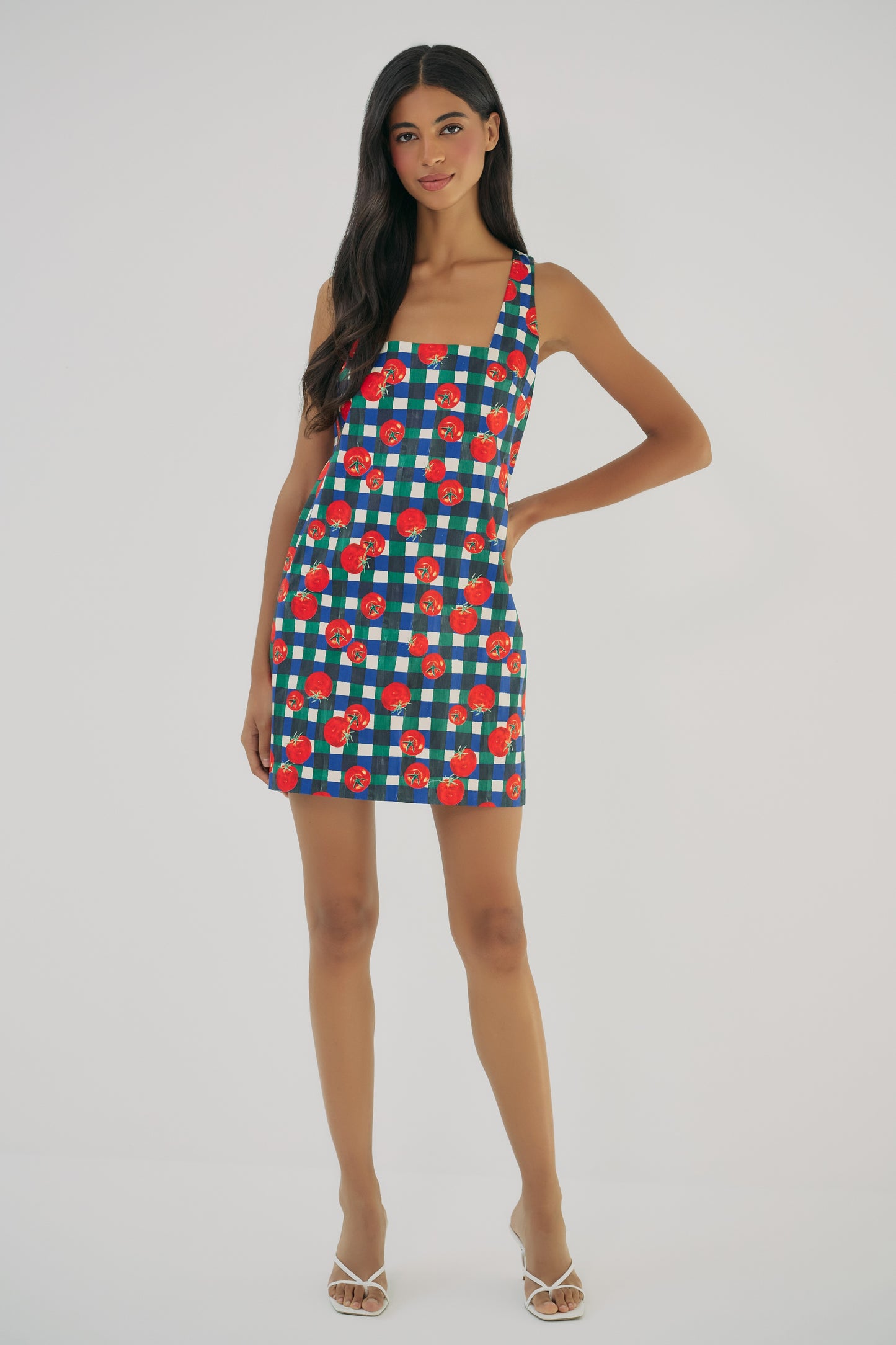 Model wearing Sara mini dress in gingham tomato print with tailored fit and sleeveless square neckline front view