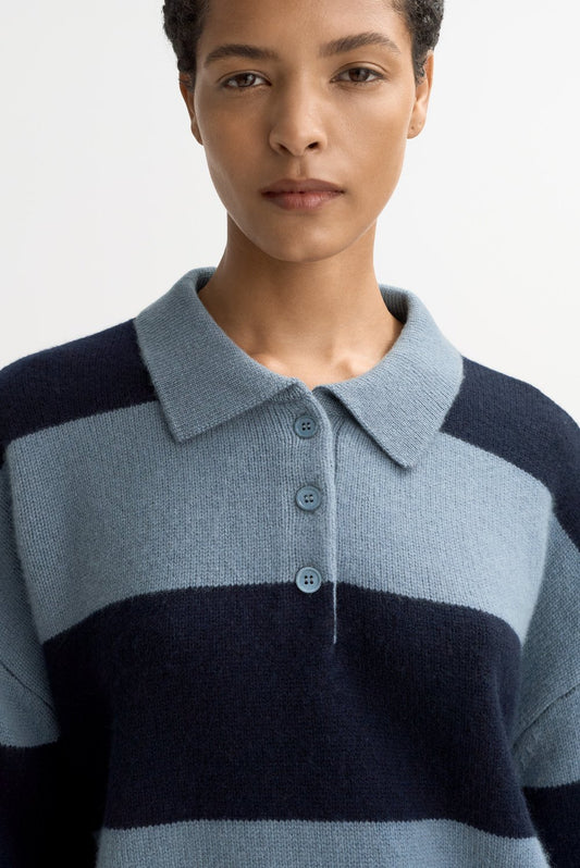 Close-up detail of the Striped Polo Shirt in Retro Blue highlighting the soft cashmere knit texture, polo collar, and three-button placket.