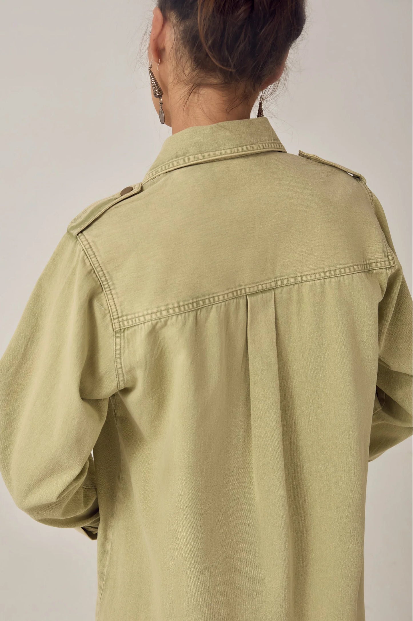Close-up back detail of the Thalassa Short Dress in Army Khaki highlighting the shoulder epaulets, soft pleating, and cotton twill fabric.