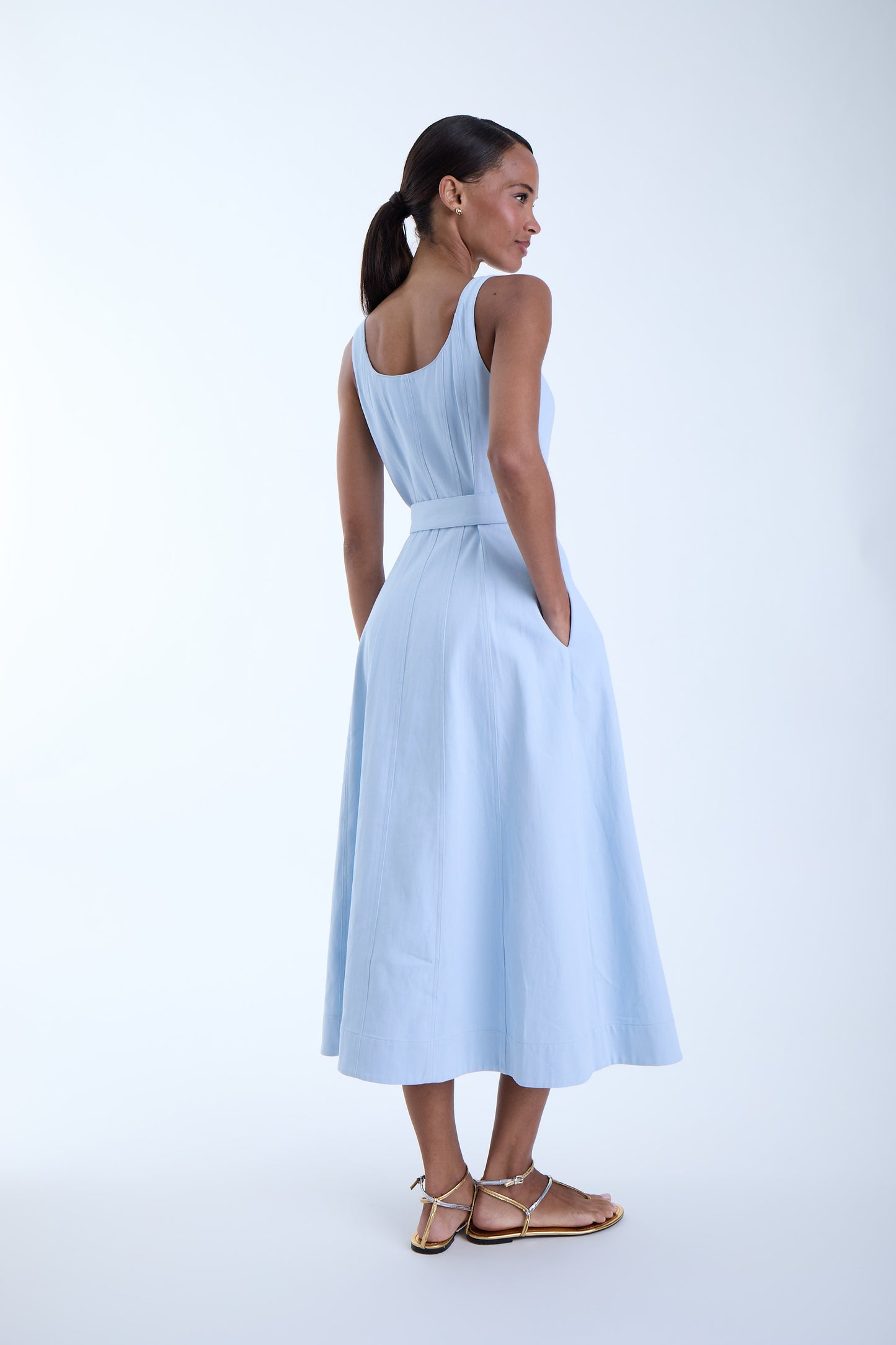Back view of the Zyra Denim Midi Dress in sky blue featuring a sleeveless silhouette, fitted waist, and softly flared midi skirt.