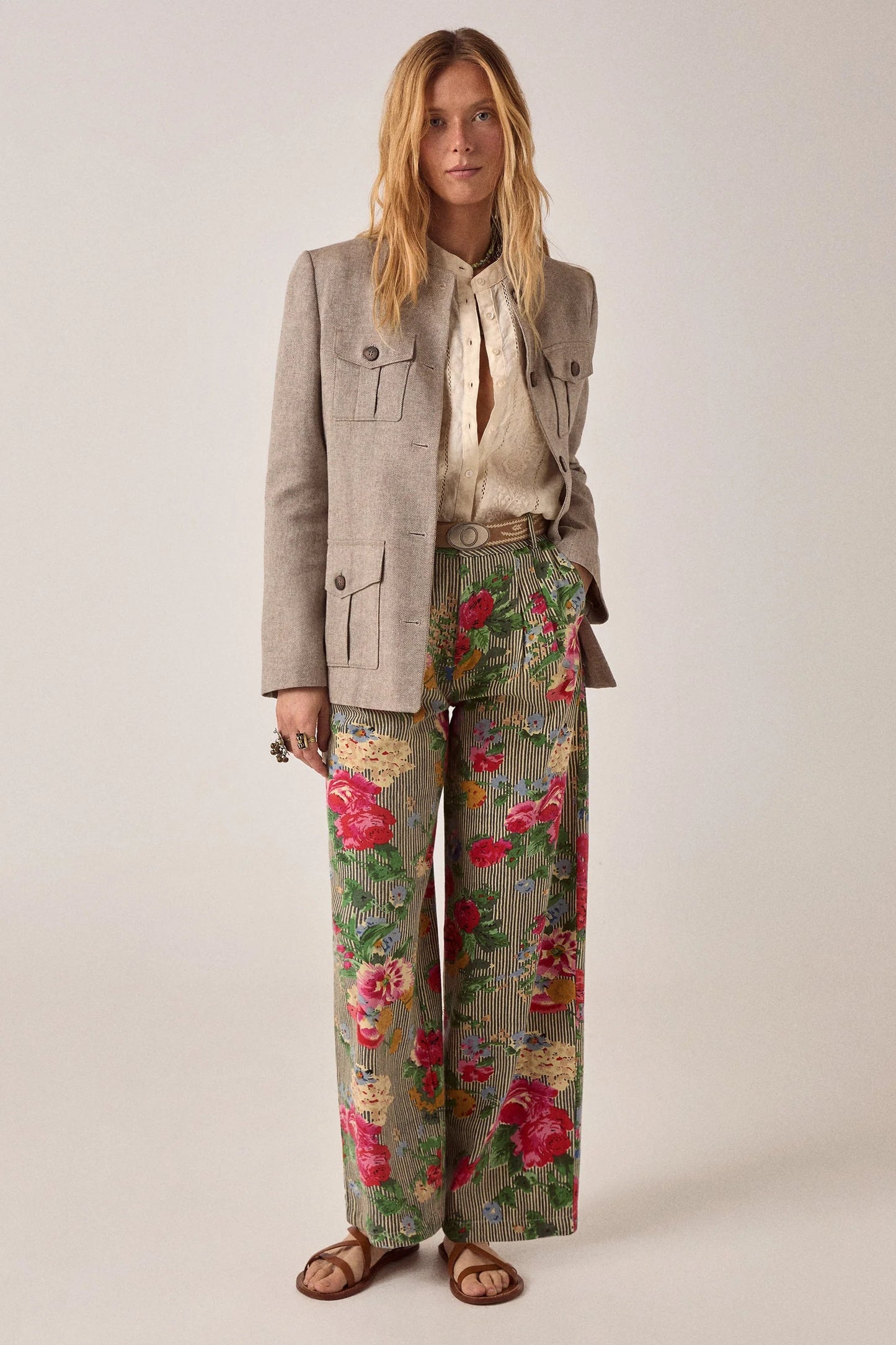 Model wearing the Maison Hotel Pepe Pant in Hulton Soul Noir styled with an ivory blouse and tailored Nehru jacket, showcasing the vibrant floral stripe print.