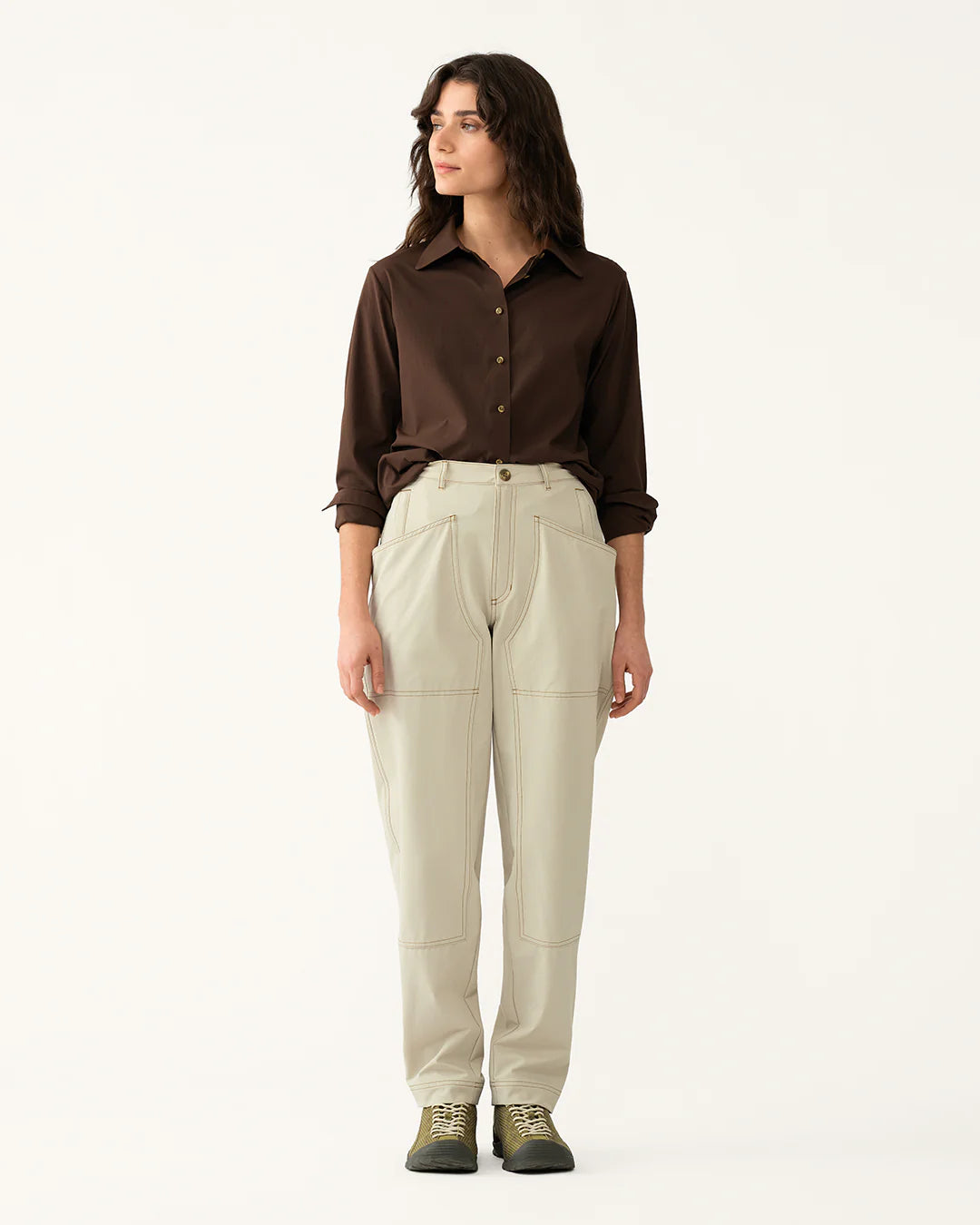 Model wearing 8 Pocket Pants in Dolomite styled with a brown shirt and trail shoes