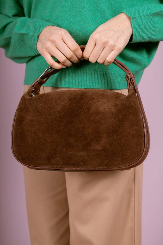 Close-up of the AMICIE Suede Bag in Khaki held by its top handle.
