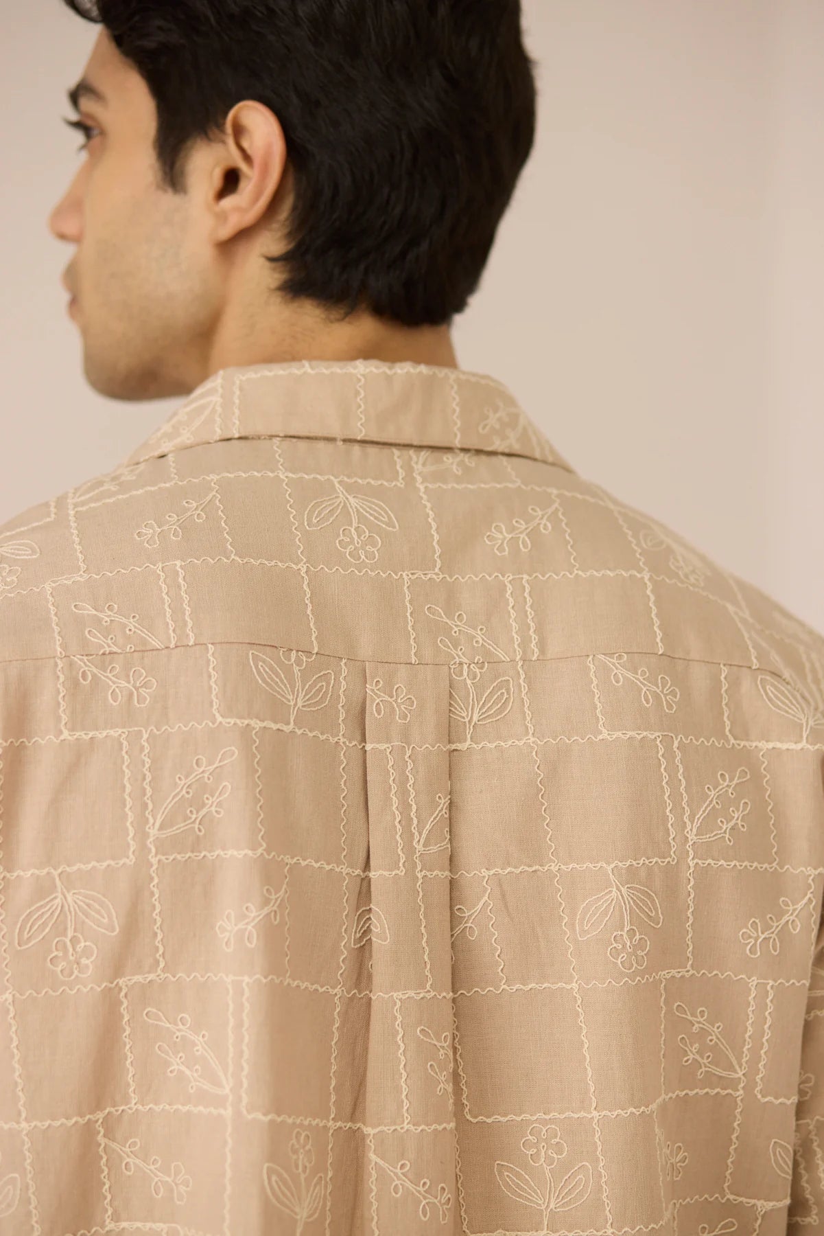 Close-up back detail of the Aiden Shirt, highlighting the subtle grid embroidery on beige cotton linen fabric.