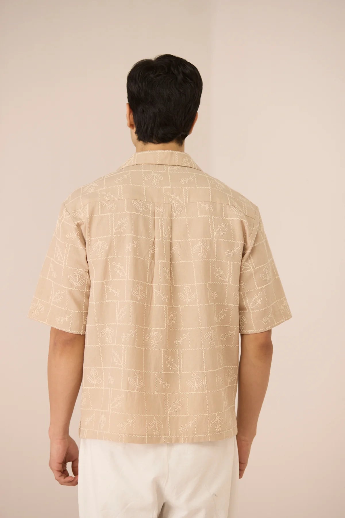 Back view of male model wearing the Aiden Shirt, showing the relaxed fit and short-sleeve shape.