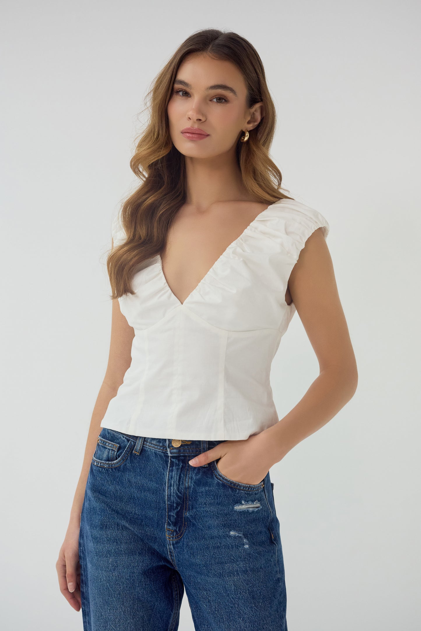 Aiko V-Neck Top in white, full front view styled with denim