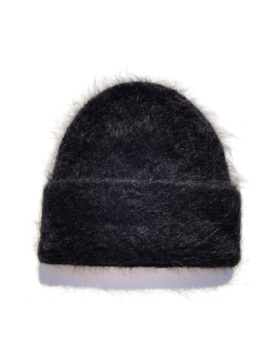 Black alpaca fluffy beanie with a soft, fuzzy texture and simple cuffed silhouette on a white background.