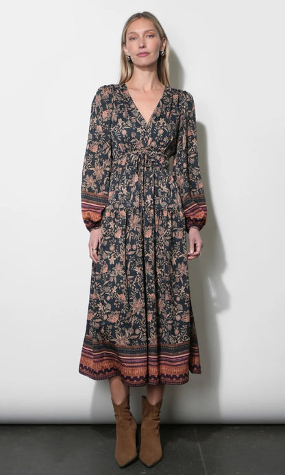 Front view of the Amber Boho Bordered Midi Dress in Navy featuring a V-neckline, drawstring waist, and tiered midi skirt.