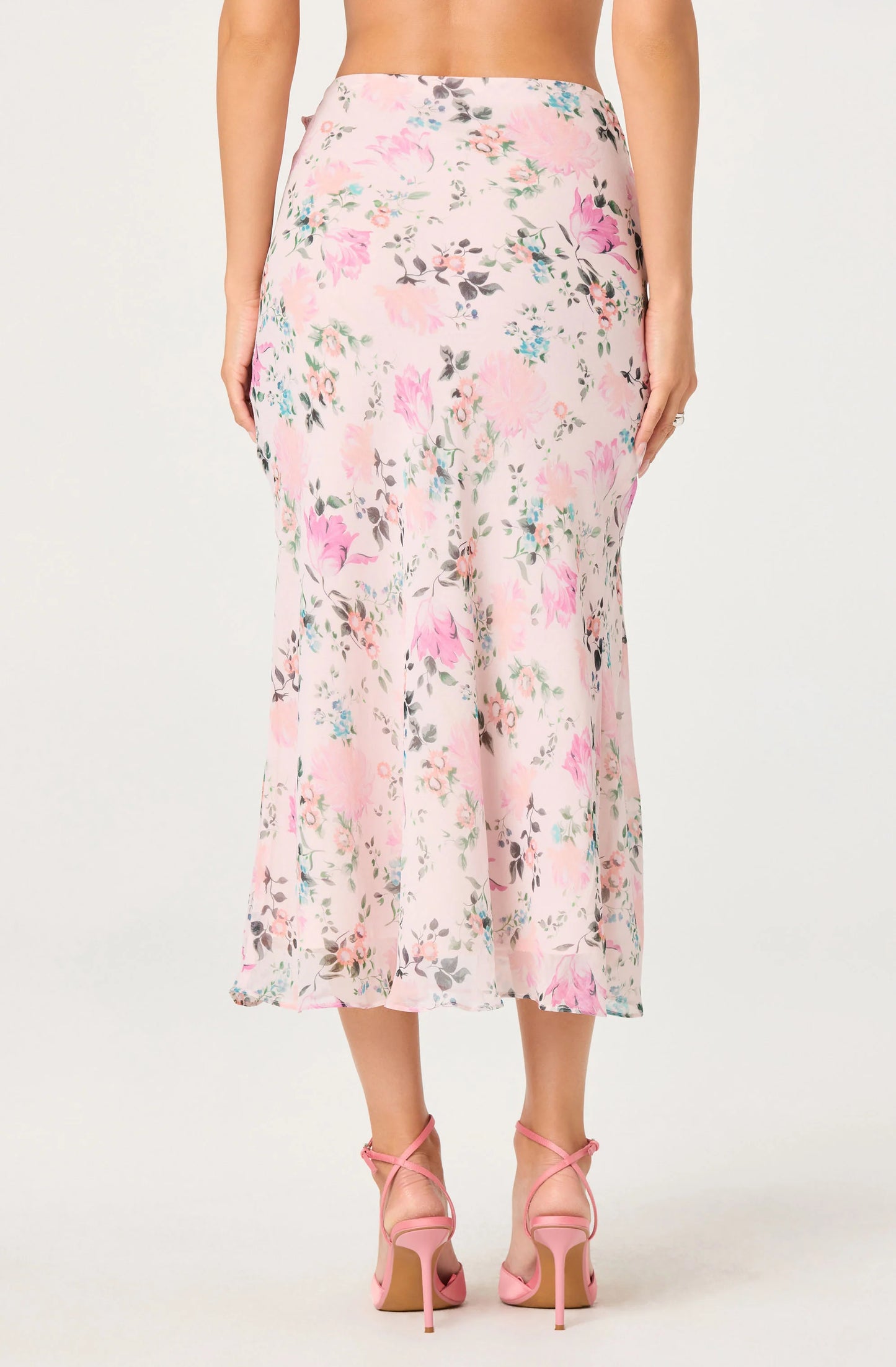 Back view of the Ananda Floral Bias-Cut Ruffle Midi Skirt showing the floral print, midi length, and flowing bias-cut silhouette.