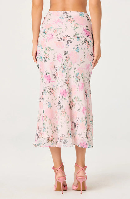 Back view of the Ananda Floral Bias-Cut Ruffle Midi Skirt showing the floral print, midi length, and flowing bias-cut silhouette.