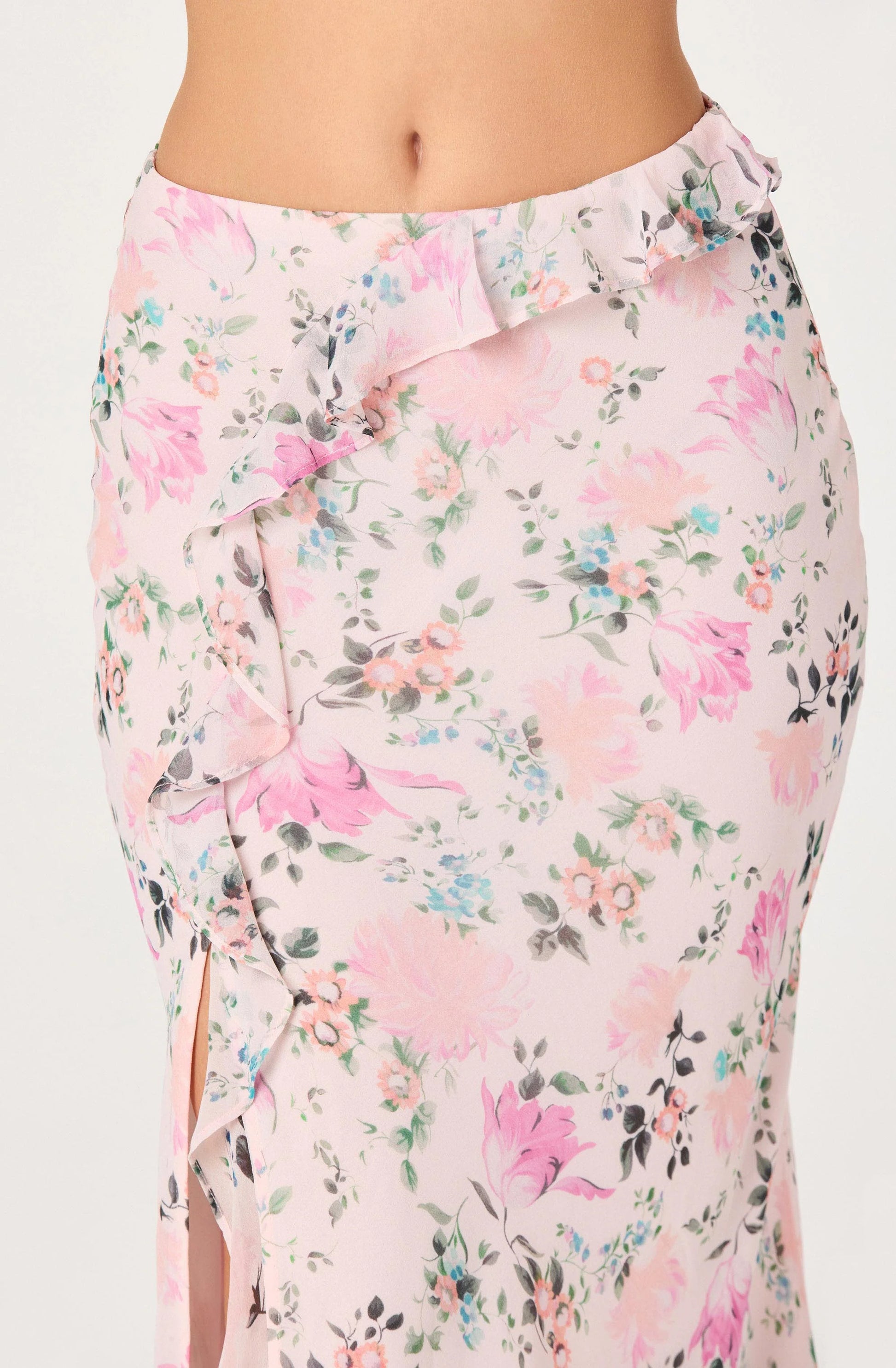 Front view of the Ananda Floral Bias-Cut Ruffle Midi Skirt showing the blush floral chiffon, asymmetric ruffle detail, and front side slit.