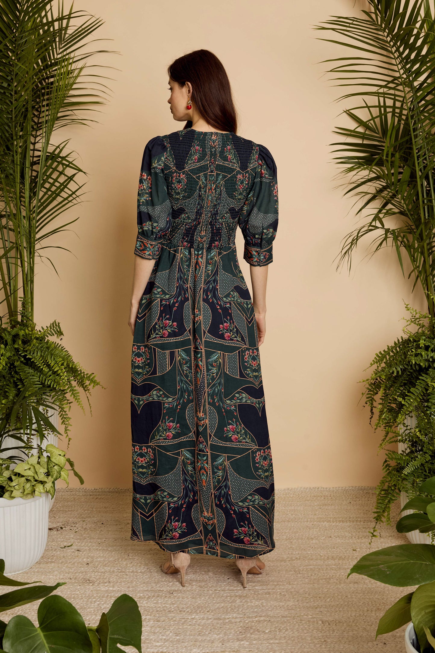 Back view of the Aneta Dress in Patchwork Flower showing the smocked back bodice and flowing maxi silhouette