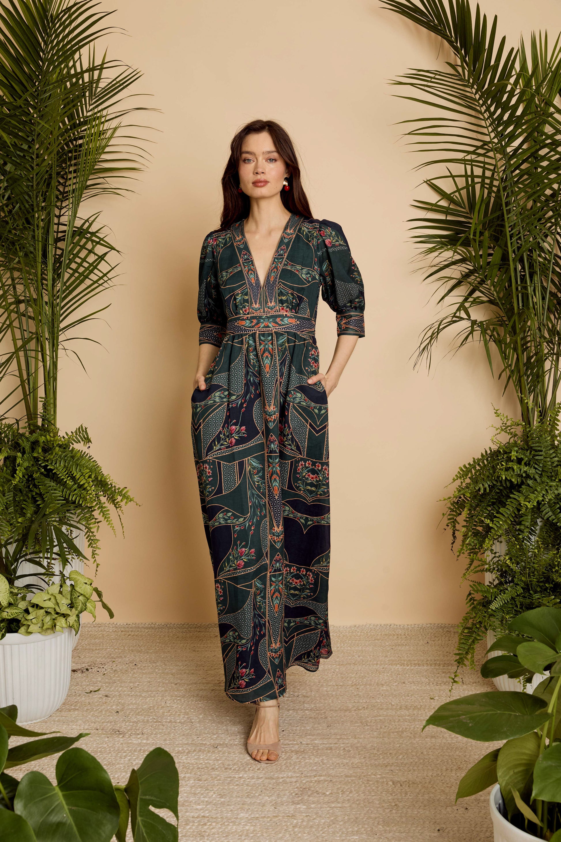 Full-length view of model wearing the Aneta Dress in Patchwork Flower with hands in pockets, highlighting the relaxed drape and maxi length