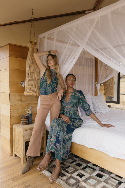 Model wearing the Aneta Dress in Patchwork Flower in an editorial lifestyle setting, highlighting the patchwork floral print and long silhouette