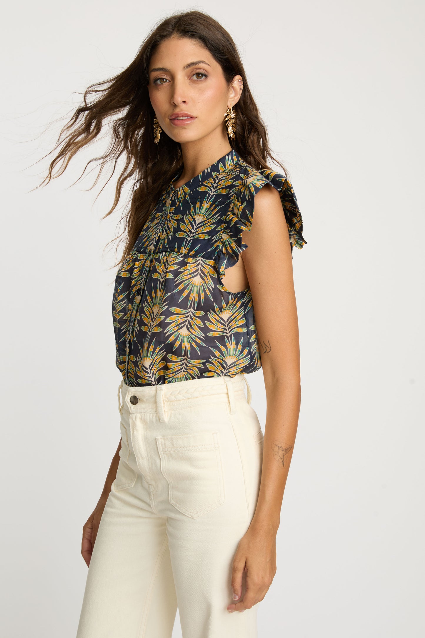 Side profile of the Anthea Top in Deco Plume showcasing flutter sleeves, lightweight fabric, and tropical leaf print detailing.
