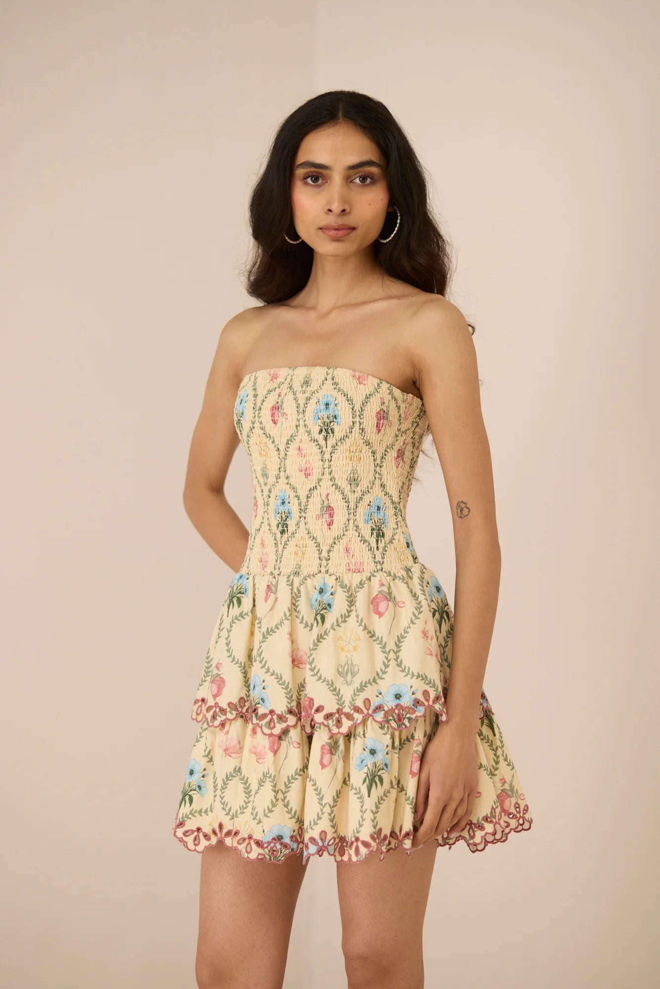 Three-quarter view of the Apricot Mini Dress featuring a soft Blue Meadow print and two-tiered skirt.