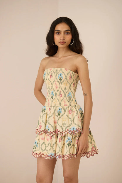 Three-quarter view of the Apricot Mini Dress featuring a soft Blue Meadow print and two-tiered skirt.