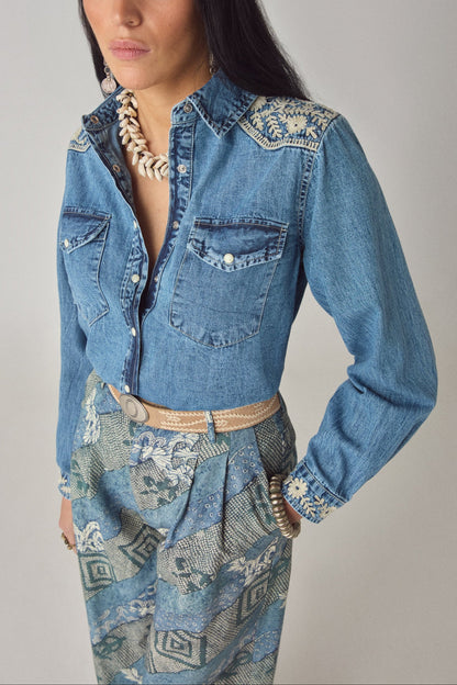 Close-up front detail of the Arizona Thelma denim shirt featuring floral embroidery on the shoulders and chest flap pockets