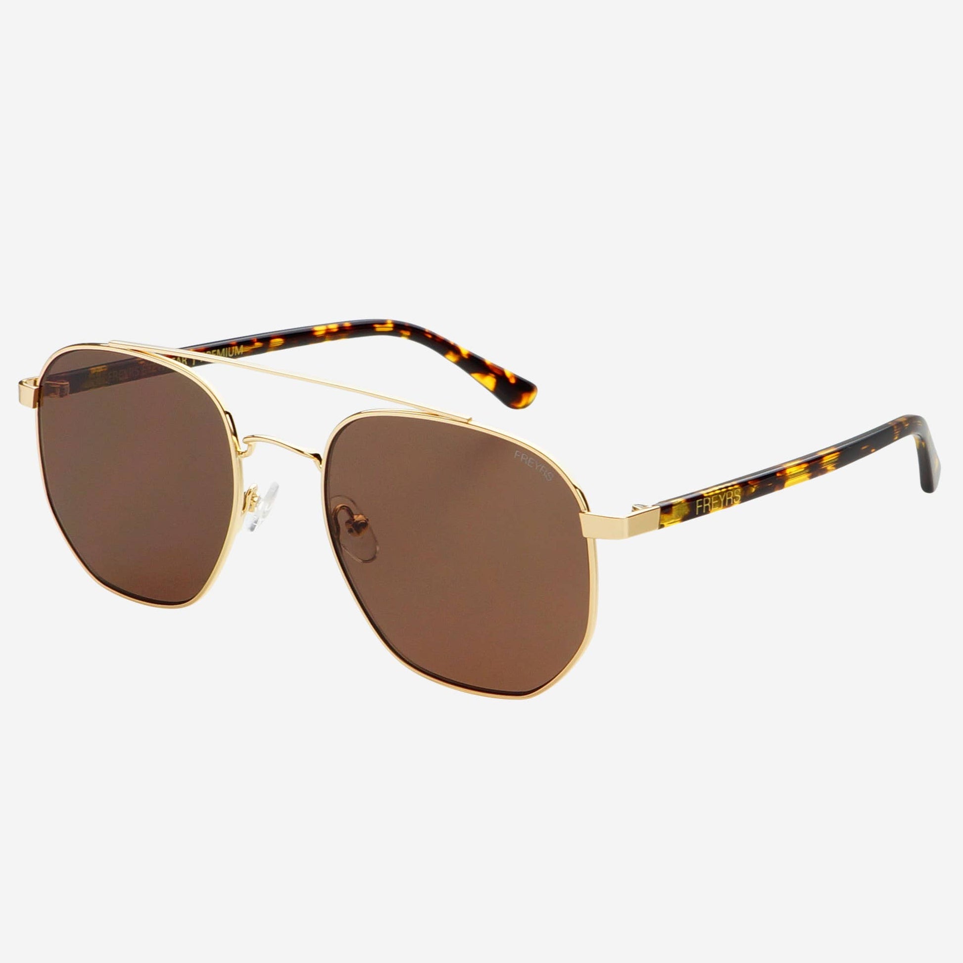 Austin Unisex Sunglasses in gold with brown lenses, shown at an angled side view with tortoise acetate arms.
