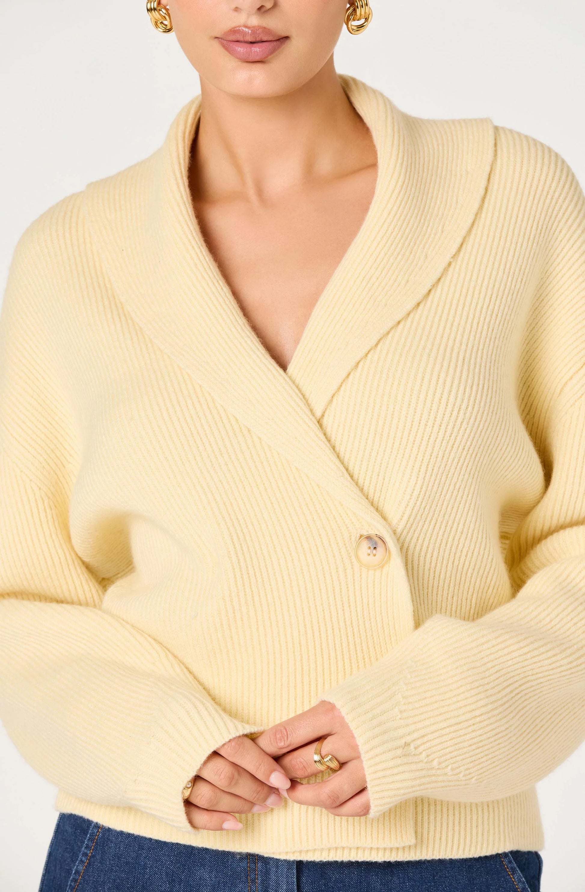 Close-up of the Ayleen Ribbed Wrap Cardigan showing the Butter Yellow ribbed knit, wrap neckline, and button-front closure.