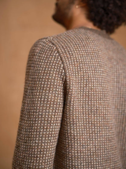 Back view of model wearing the Beacon Sweater in Walnut, showing the allover birds-eye knit pattern.
