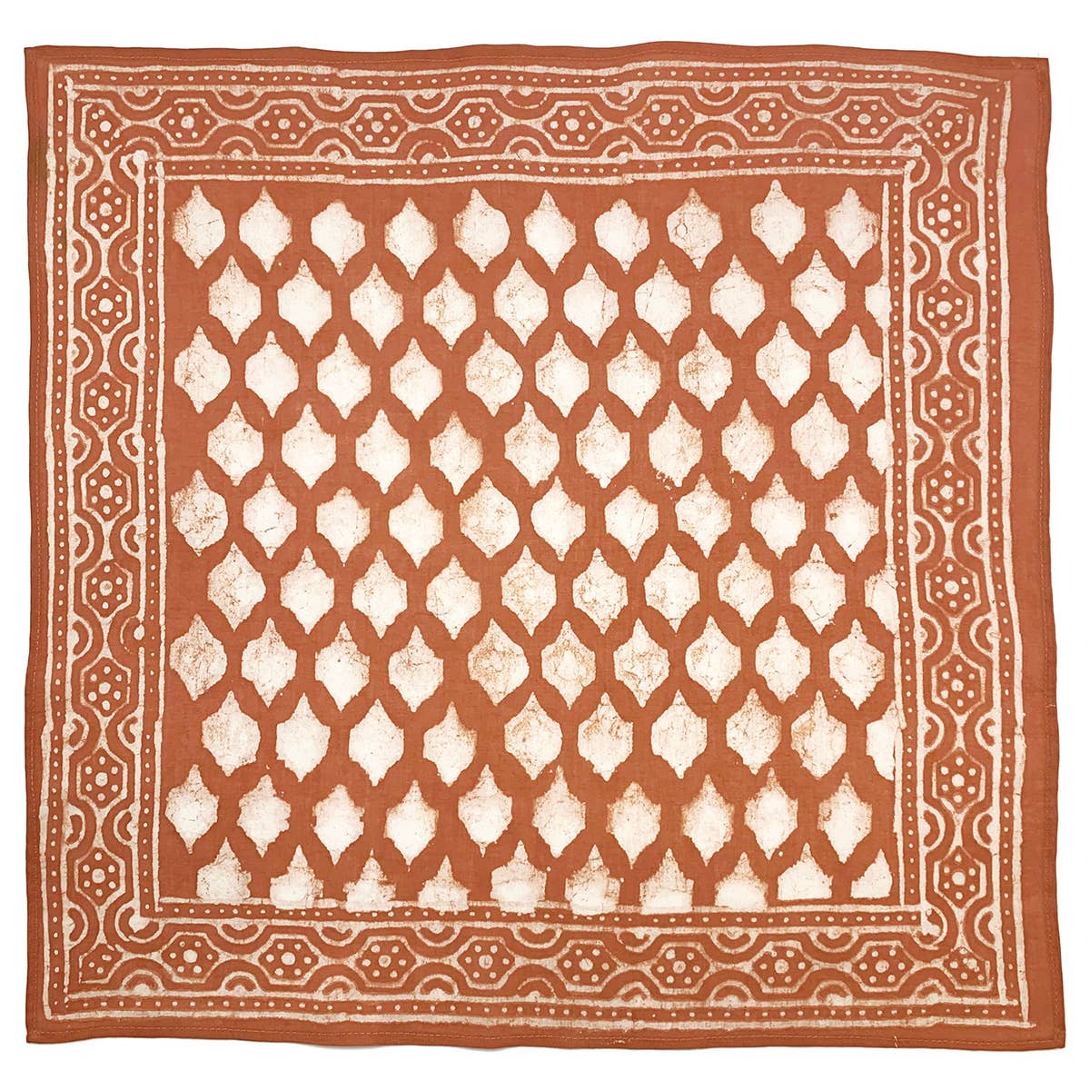 Square burnt orange cotton bandana featuring a hand block printed tile grid motif with an ivory geometric border. Crafted from lightweight, ultra-soft cotton using traditional block printing techniques and eco-friendly dyes.