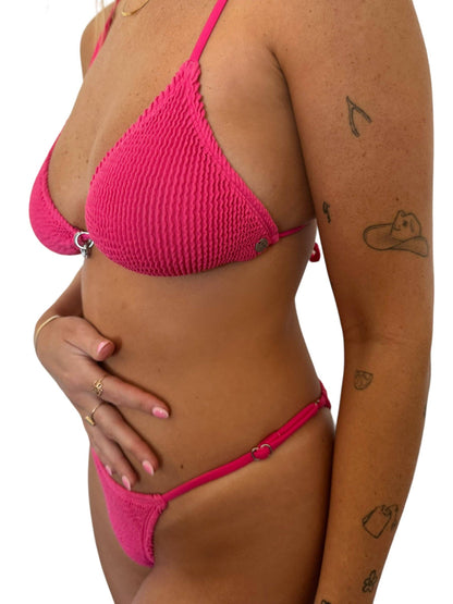 Side close-up of the Bristen Bottom in Petunia showing the pink ribbed texture, adjustable fit, and string-style silhouette.