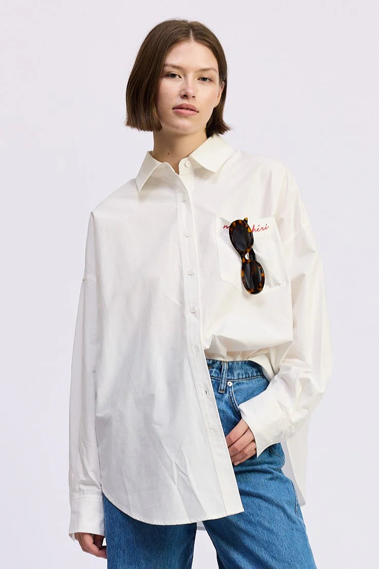 Close-up of the Brittany Oversized Shirt in white featuring mon chéri embroidered chest pocket