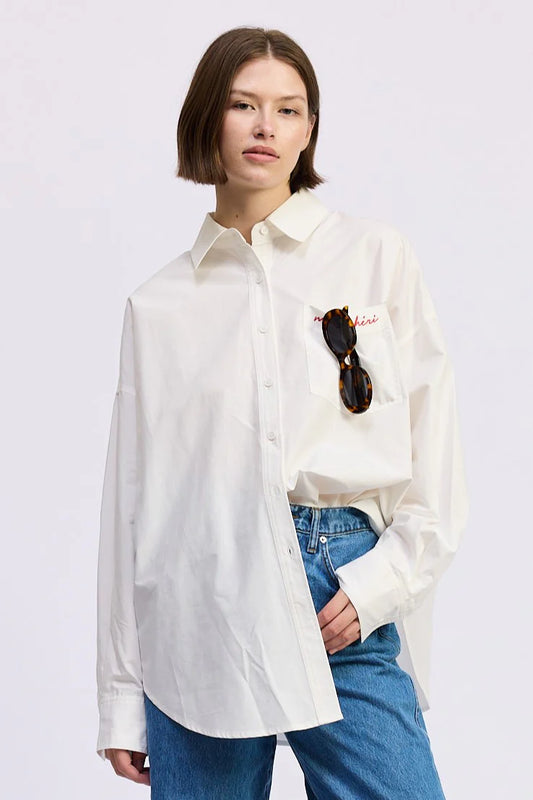 Close-up of the Brittany Oversized Shirt in white featuring mon chéri embroidered chest pocket