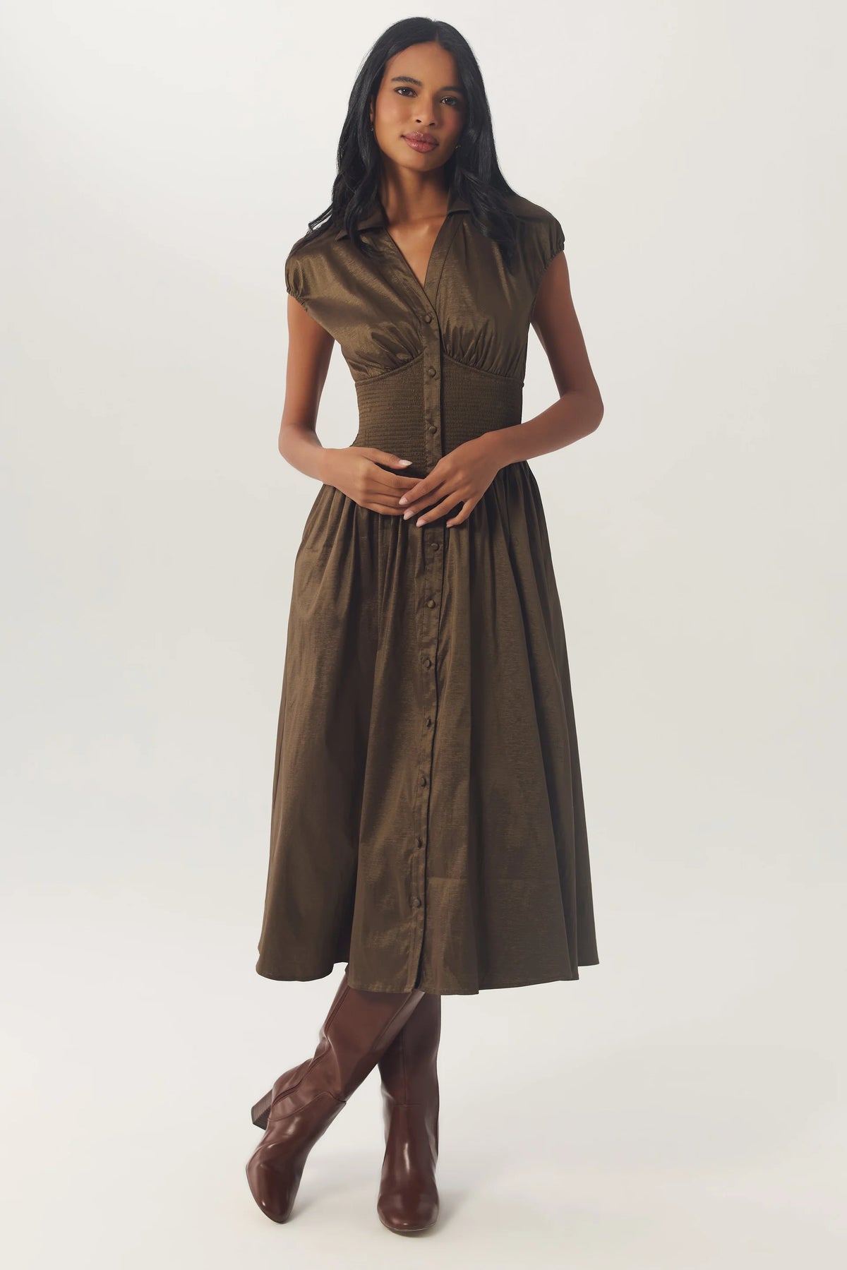 Model wearing the Olive Brynny Dress with a full midi skirt and brown knee-high boots.