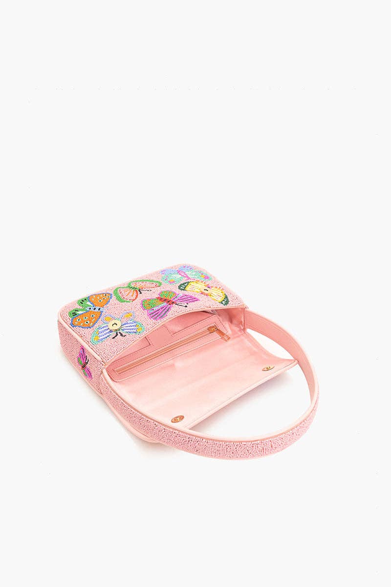 Side view of the Butterfly Garden Beaded Shoulder Bag showing the structured body, light pink strap, and beaded butterfly flap design.