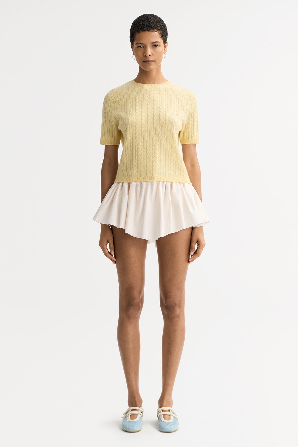 Model wearing the honeydew yellow cable knit cashmere top with a crewneck and short sleeves