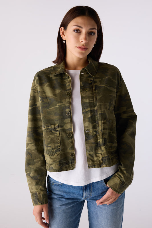 Woman wearing the Little Rowdy Cadet Jacket in camo with front button closure and patch pockets