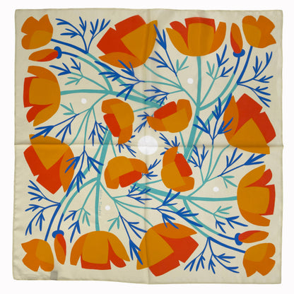 California Poppies 100% silk scarf laid flat, featuring orange poppies with blue and green botanical stems on a warm neutral background.