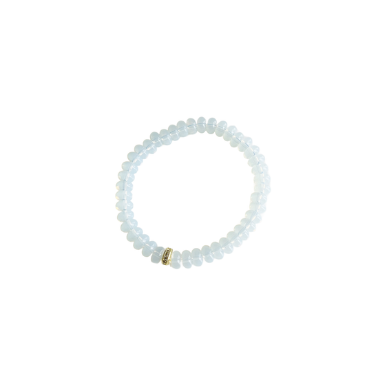 Opaline beaded stretch bracelet with a gold pavé spacer bead on a white background.