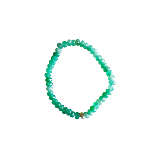 Green ocean jade beaded stretch bracelet with a pavé spacer bead on a white background.