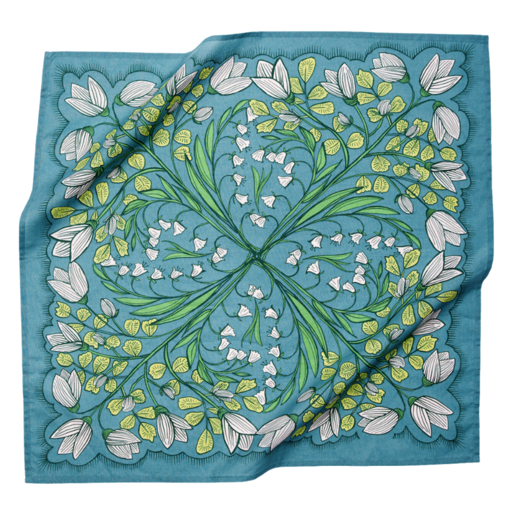 Cassie bandana in teal floral multi shown draped flat, featuring white flowers, green botanical details, and a square cotton design.